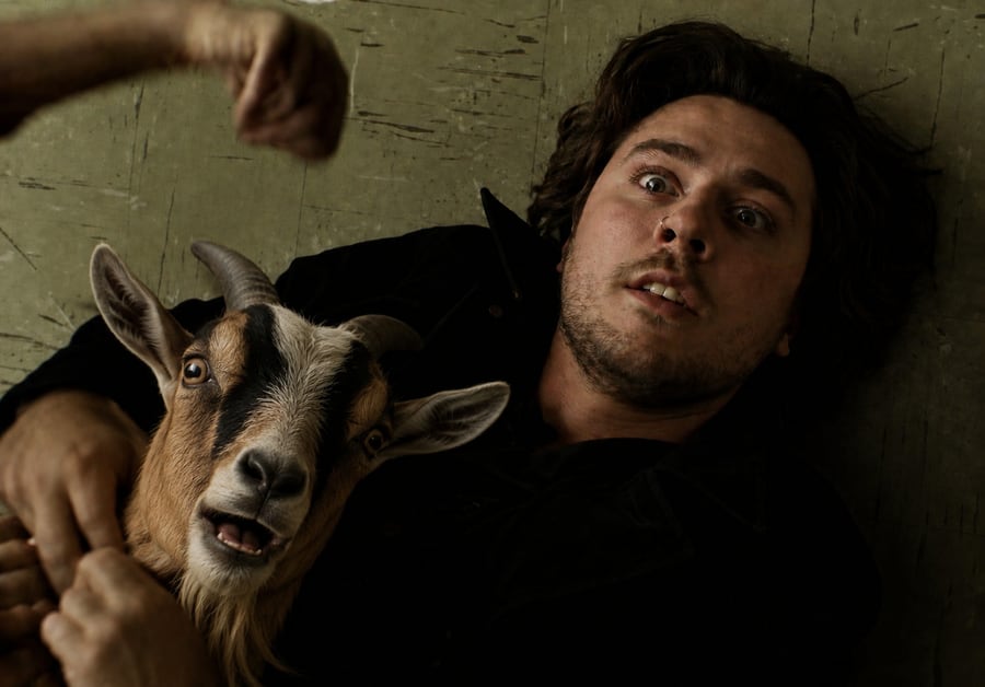 James 'Jimmy' Hockless lying beside a goat
