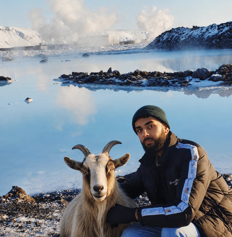 Satnam Singh beside a goat at a geothermal lake